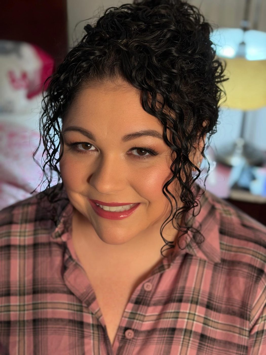 A bride with her natural curls styled for the wedding day