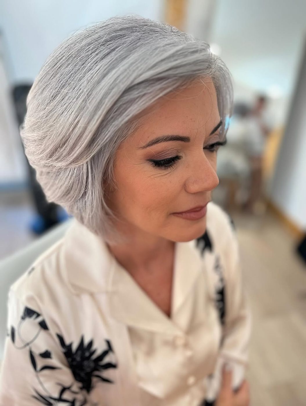 Softly waved silver hair and natural makeup for a mother of the bride