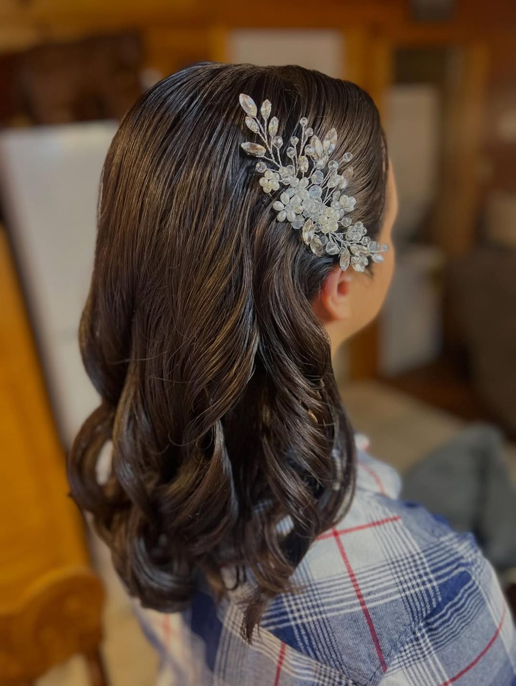 Bridal hair styled from behind and finished with a crystal comb